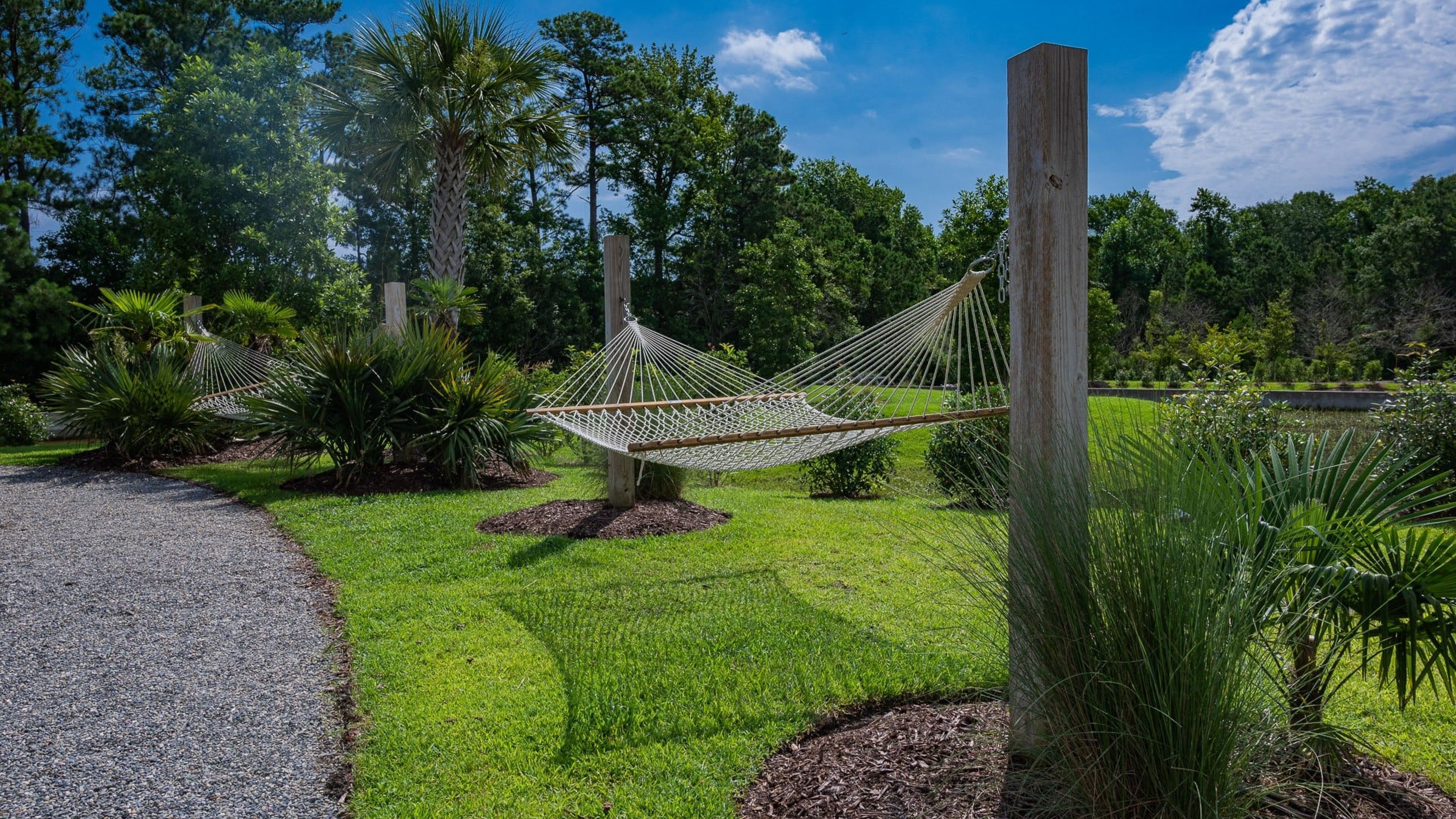 Hawthorne at the Station outdoor lawn with hammocks and tropical landscaping